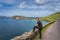 Middle age man watching and admiring amazing view of Slea Head and Dingle Peninsula