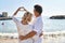 Middle age man and woman couple doing heart symbol with hands at seaside