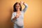 Middle age pregnant woman expecting baby at aged pregnancy smiling making frame with hands and fingers with happy face