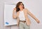 Middle age senior business woman standing on seminar presentation by magnectic blackboard Dancing happy and cheerful, smiling