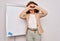 Middle age senior business woman standing on seminar presentation by magnectic blackboard Doing heart shape with hand and fingers