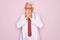 Middle age senior grey-haired doctor man wearing stethoscope and professional medical coat rubbing eyes for fatigue and headache,