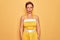 Middle age senior pin up woman wearing 50s style retro dress over yellow background depressed and worry for distress, crying angry