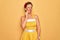 Middle age senior pin up woman wearing 50s style retro dress over yellow background touching mouth with hand with painful