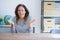 Middle age senior woman sitting at the table at home smiling cheerful offering hands giving assistance and acceptance