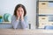 Middle age senior woman sitting at the table at home Tired hands covering face, depression and sadness, upset and irritated for