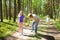 Middle age woman applying insect repellent to her granddaughter before forest hike beautiful summer day. Protecting children from