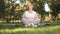 Middle age woman deeply breathing and meditating sitting in lotus position