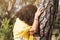 middle age woman embracing trees while meditating on the forest.