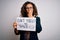 Middle age woman holding banner with dont forget smile message over white background cover mouth with hand shocked with shame for