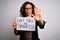 Middle age woman holding banner with dont forget smile message over white background with open hand doing stop sign with serious