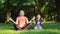 Middle age woman mother with child meditate together in park