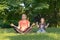 Middle age woman mother with child meditate together in park