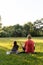 Middle age woman mother with child meditate together in park