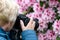 Middle age woman photographing the blooming rhododendrons