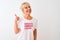 Middle age woman wearing fanny t-shirt with irony comments over isolated white background happy with big smile doing ok sign,