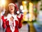 Middle age woman wearing Santa Claus costume crazy and mad shouting and yelling with aggressive expression and arms raised