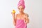Middle age woman wearing shower towel holding duck toy over  white background pointing with finger to the camera and to