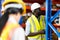 Middle aged African American warehouse worker preparing a shipment in large warehouse distribution centre