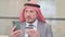 Middle Aged Arab Businessman with Successful Online Payment on Smartphone