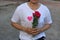 Middle aged asian woman is holding a beautiful bouquet of red roses. Love and romance Valentine`s day concept.