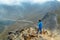 A middle aged backpacker looking over the Quilotoa volcanic crater lagoon