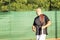 A middle-aged bald man emotionally plays tennis on the court. Loses the opponent. Outdoor