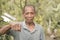 A middle aged and balding rural Filipino man offers a fist bump as a greeting. Fraternity bond among friends or a show of respect