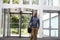 Middle aged black man in the foyer of a large modern building