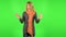 Middle aged blonde woman strictly gesturing with hands crossed making X shape meaning denial saying NO. Green screen