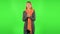 Middle aged blonde woman is waiting in anticipation with pleasure. Green screen