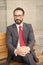 Middle-aged businessman taking a relaxing break on bench. City Life Series of business persons. Portrait of a businessman sitting