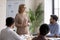 Middle-aged businesswoman lead meeting with employees in office