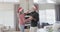 Middle aged caucasian couple in santa hats dancing at christmas at home, slow motion