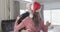 Middle aged caucasian couple in santa hats dancing at christmas at home, slow motion