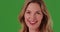 Middle aged Caucasian woman laughing at camera on green screen