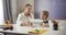 Middle aged caucasian woman and little schoolgirl sitting at the table with tablet and learning math. Education