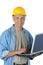 Middle aged Construction Worker Holding Laptop