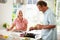 Middle Aged Couple Cooking Meal In Kitchen Together