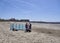 A middle Aged Couple erecting a Wind Shelter on the Beach at Beadnell Bay in Northumberland.