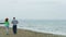 Middle-aged couple jogging on seaside beach in the morning. Healthy lifestyle