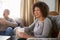 Middle Aged Couple Meeting Friends Around Table In Coffee Shop