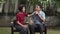 Middle aged couple relax sitting on bench in backyard