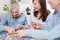 Middle-aged family elderly collects jigsaw puzzles at the table in the room