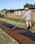 Middle-aged Farmhand Raking Dried Sultanas.