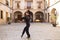 Middle-aged flamenco man with long hair dancing flamenco in a square with columns and balconies in seville, spain. Feel the