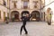 Middle-aged flamenco man with long hair dancing flamenco in a square with columns and balconies in seville, spain. Feel the