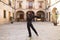 middle-aged flamenco man with long hair dancing flamenco in a square with columns and balconies in seville, spain. Feel the