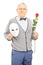 Middle aged gentleman holding rose flower and mask