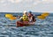 Middle-aged husband and wife enjoying a kayaking adventure in the Atlantic Ocean near Bar Harbor, Maine.